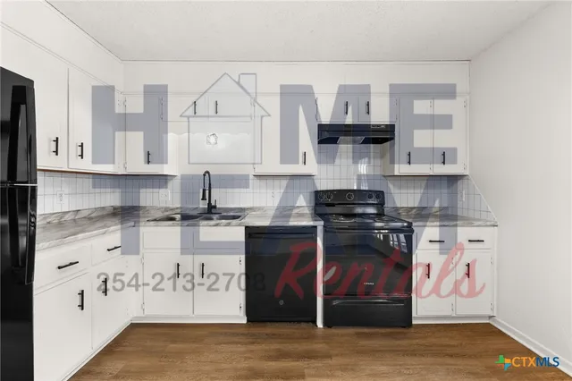 a kitchen with stainless steel appliances granite countertop a stove and cabinets