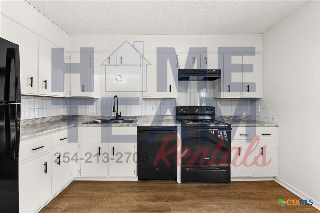 1005 Eastside Drive, Unit B Killeen, TX 76543 - Photo 5 of 11 a kitchen with stainless steel appliances granite countertop a stove and cabinets