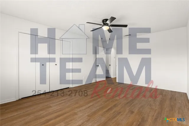 a view of a room with wooden floor