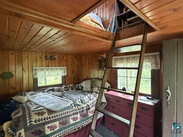 9064 Peppard Road Britt, MN 55710 - Photo 25 of 40 Wood-paneled room with a built-in loft space, accessed by a wooden ladder