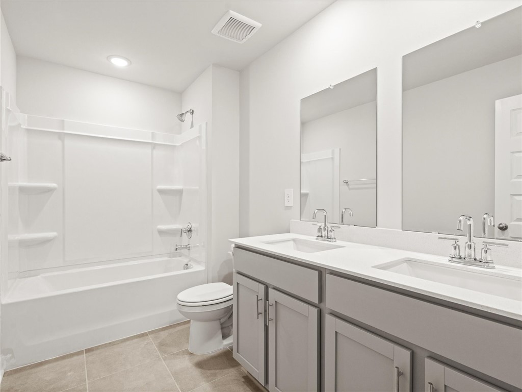 130 Blooming Mdw Road Piedmont, SC 29673 - Photo 10 of 12 Dual vanity sinks provide ample space in this crisp, well-appointed primary bathroom.