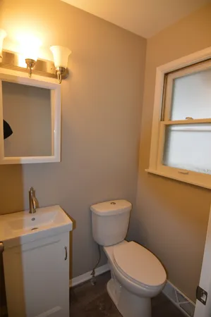 a white toilet sitting next to a bathroom sink