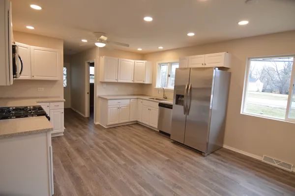 an empty room with fireplace and a window