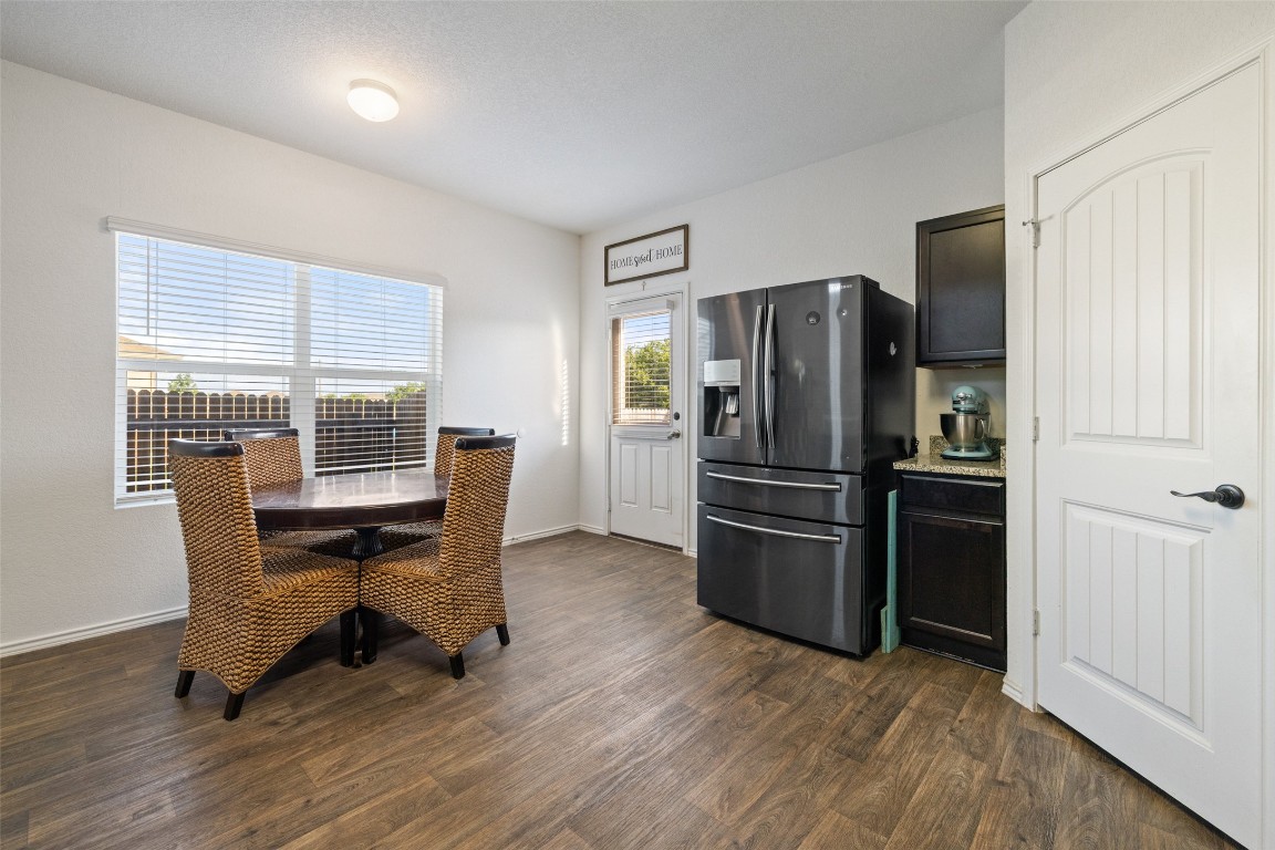 11801 Riprap Drive Manor, TX 78653 - Photo 16 of 40 a kitchen with a refrigerator and wooden cabinets
