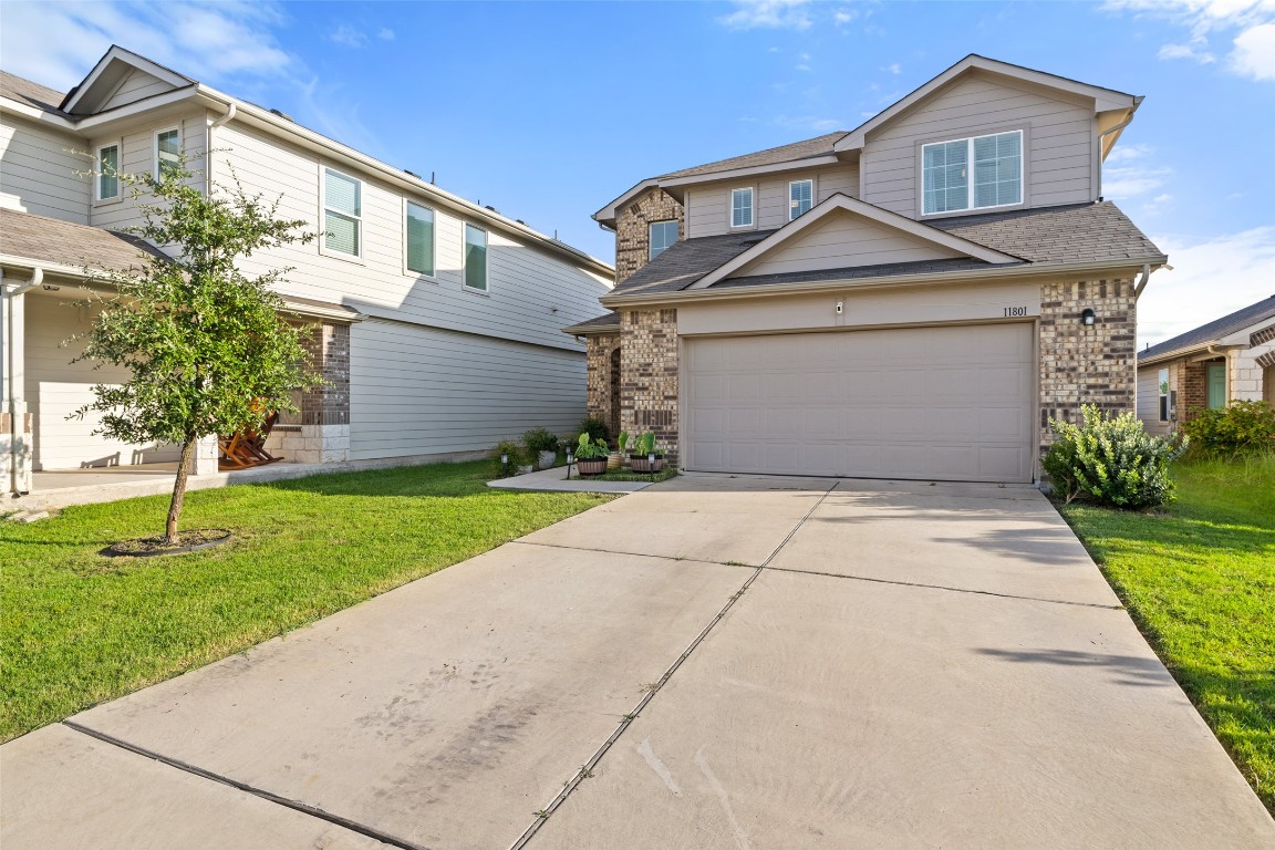 11801 Riprap Drive Manor, TX 78653 - Photo 2 of 40 a front view of a house with a yard and garage
