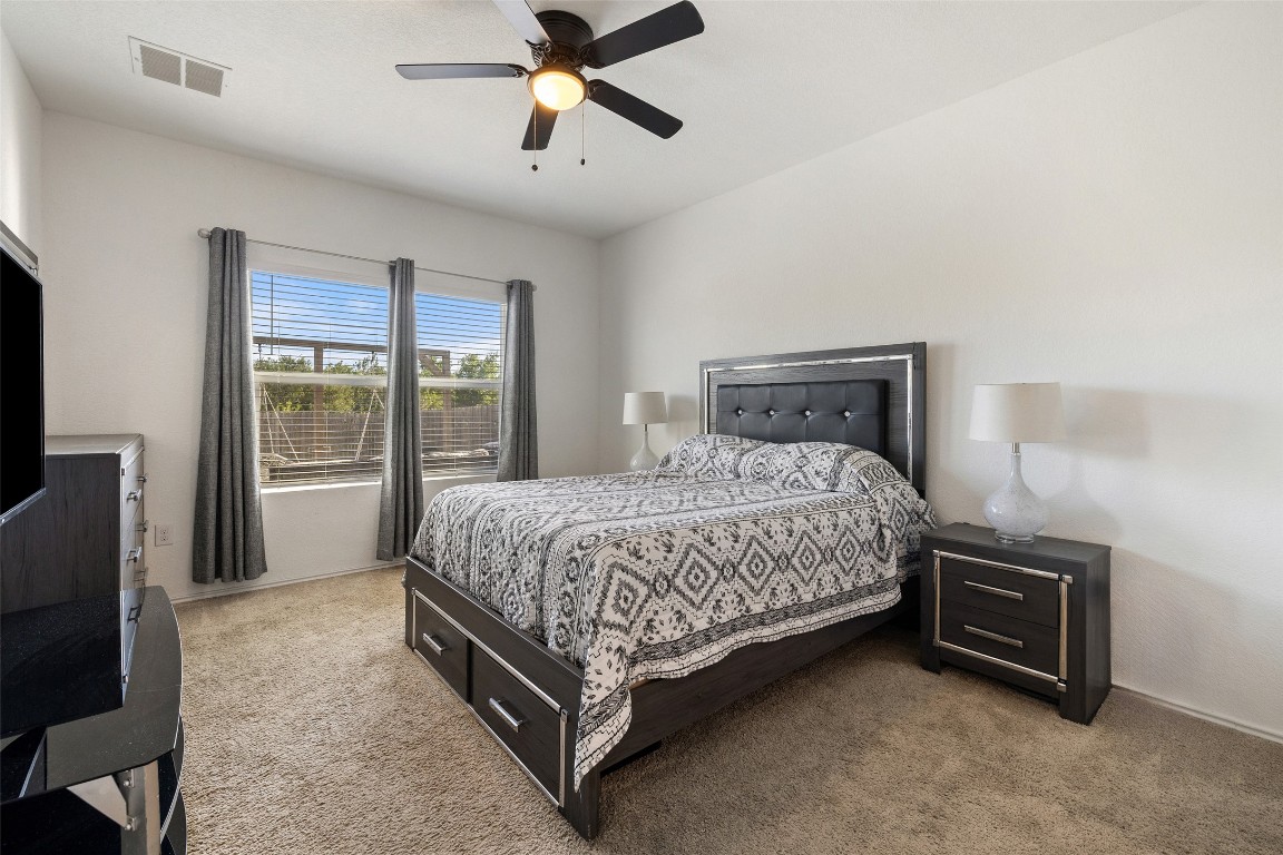 11801 Riprap Drive Manor, TX 78653 - Photo 21 of 40 a bed sitting in a spacious bedroom next to a window