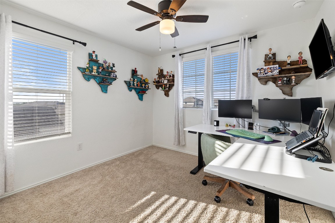 11801 Riprap Drive Manor, TX 78653 - Photo 27 of 40 a view of a workspace with furniture and a window