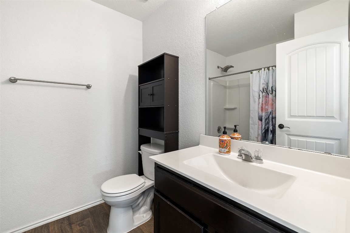 11801 Riprap Drive Manor, TX 78653 - Photo 28 of 40 a bathroom with a sink toilet and shower