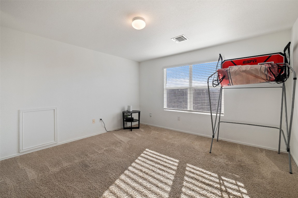 11801 Riprap Drive Manor, TX 78653 - Photo 31 of 40 a bedroom with a bed and a window