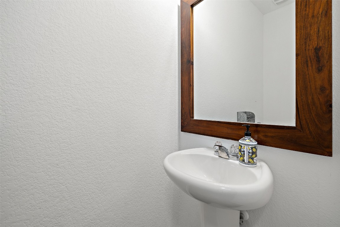 11801 Riprap Drive Manor, TX 78653 - Photo 33 of 40 a bathroom with a sink and a mirror