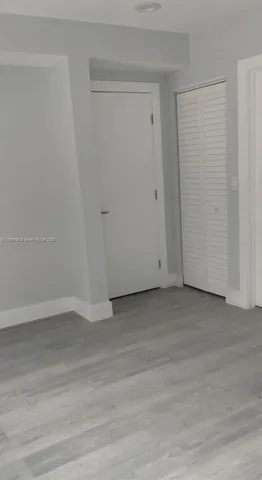 a kitchen with a white cabinets and window