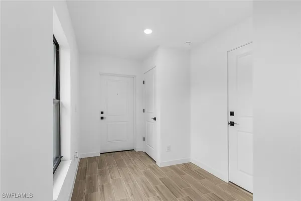 a view of a room with wooden floor