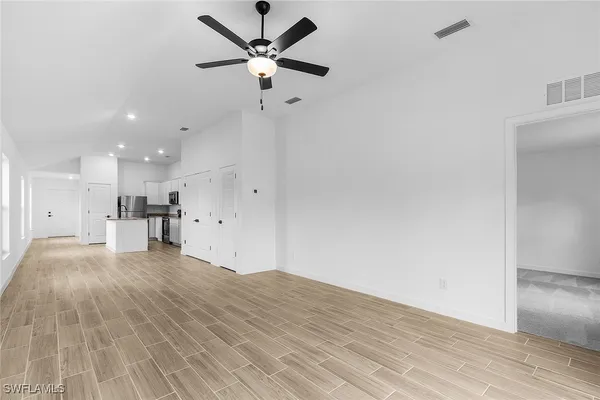 a view of kitchen with granite countertop cabinets and wooden floor