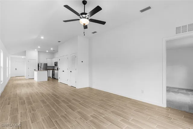 a view of kitchen with granite countertop cabinets and wooden floor