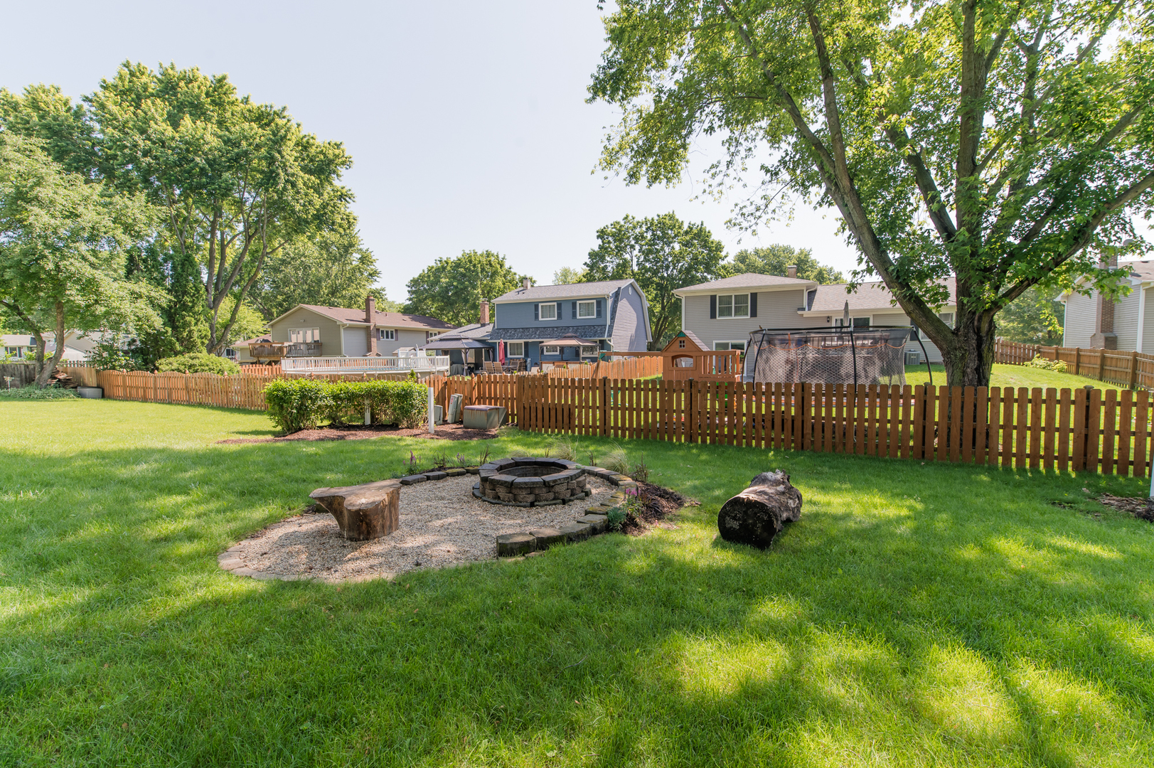 73 Fairfield Lane Cary, IL 60013 - Photo 7 of 33 a view of a garden with lawn chairs and a fire pit
