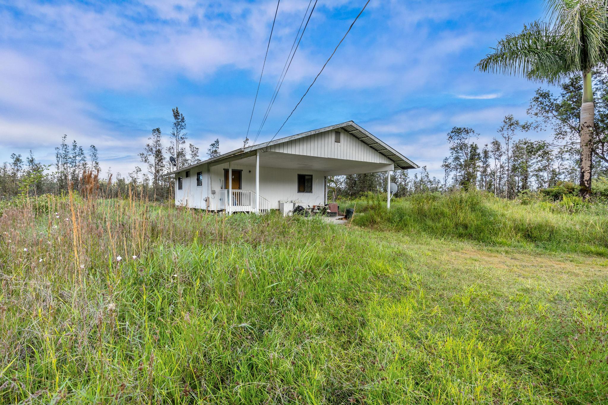 16-2071 Ao Rd Mountain View Pahoa, HI 96778 - Photo 2 of 13 a front view of a house with garden