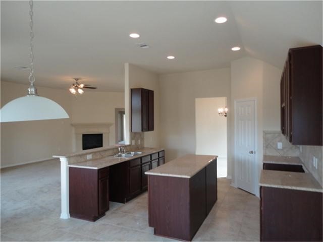 6611 Early Fall Drive Humble, TX 77338 - Photo 5 of 18 a kitchen with a refrigerator counter top space cabinets and a sink