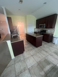 6611 Early Fall Drive Humble, TX 77338 - Photo 6 of 18 a kitchen with stainless steel appliances granite countertop a stove a sink and a microwave