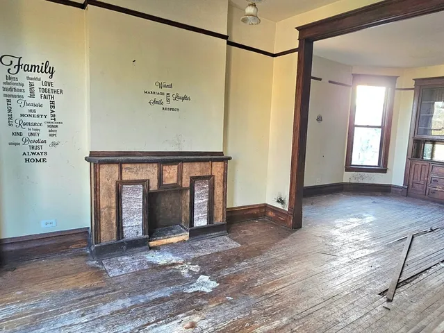 a view of empty room with wooden floor and windows