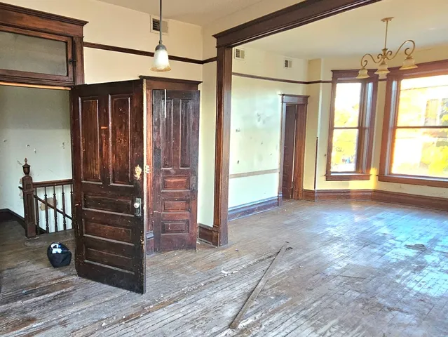 a view of a room with a window and front door
