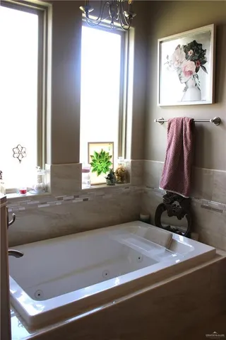 a bathroom with a bathtub and a window