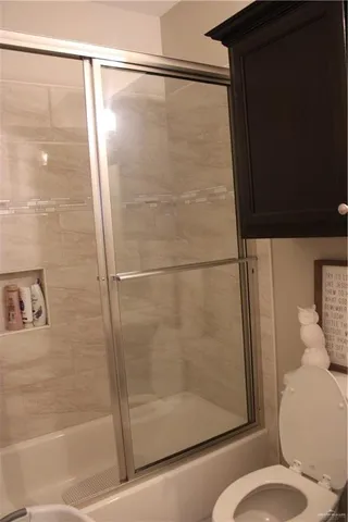 a bathroom with a shower and a toilet