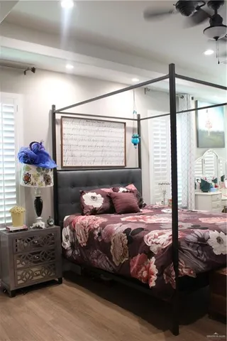 a bedroom with a bed and large window
