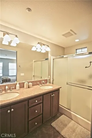 a bathroom with a double vanity sink and mirror