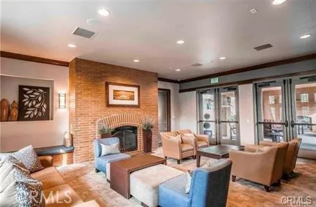 a living room with fireplace furniture and a large window