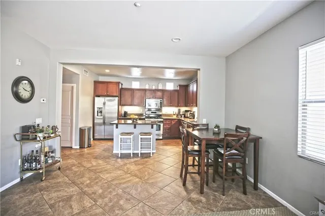 a view of a dining room with furniture and chandelier
