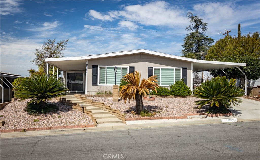 a front view of house with yard and seating space