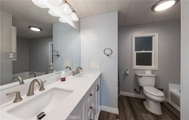 a bathroom with a sink a toilet and a mirror