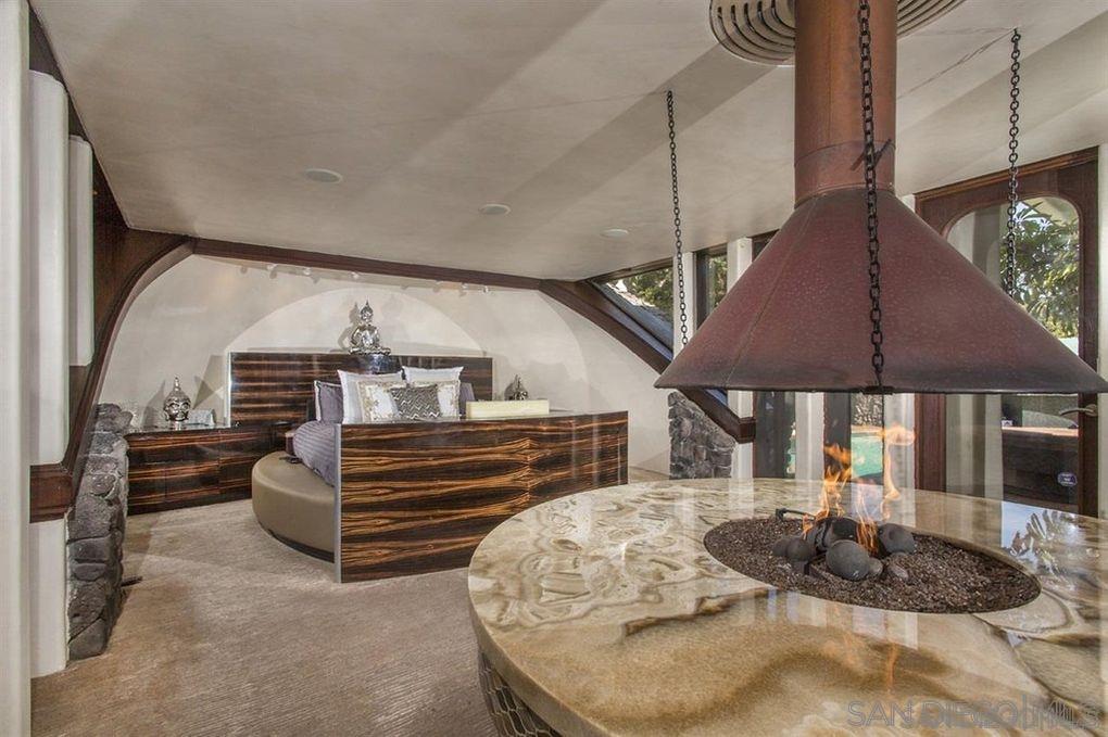 9805 Blackgold Road La Jolla, CA 92037 - Photo 12 of 32 a bed room with furniture and a fireplace