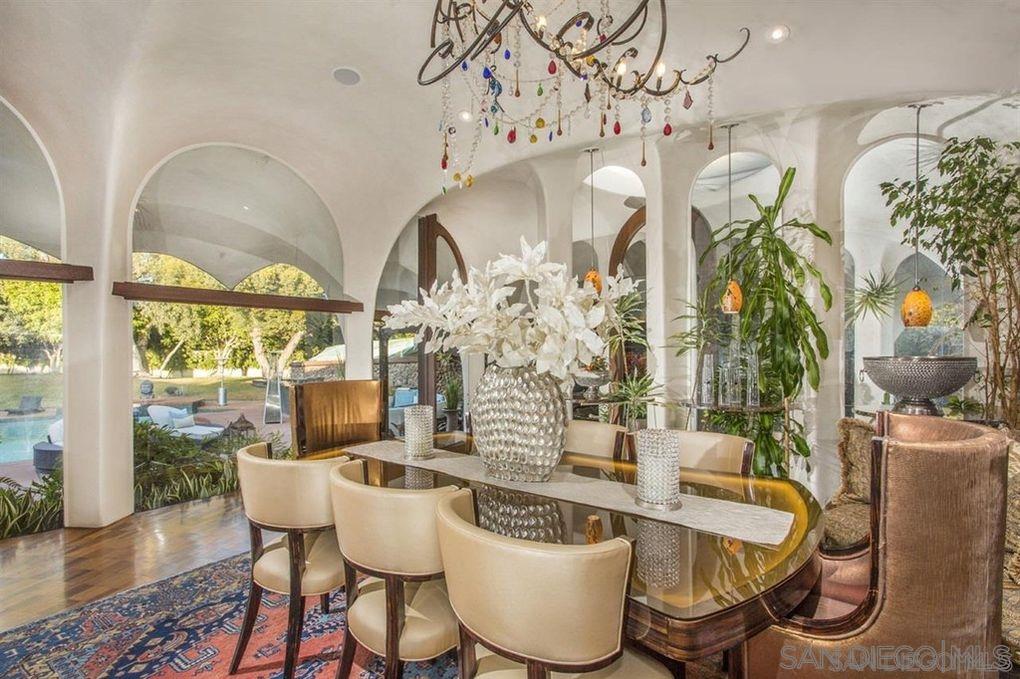 9805 Blackgold Road La Jolla, CA 92037 - Photo 13 of 32 a dining room with furniture a chandelier and wooden floor