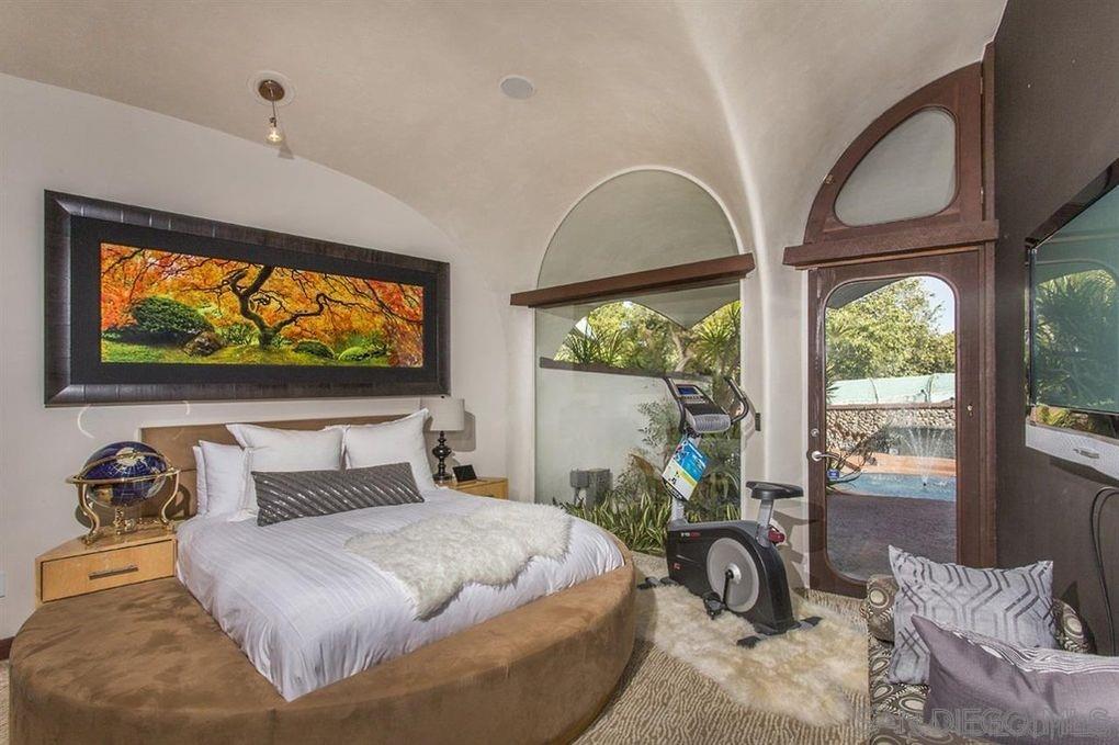 9805 Blackgold Road La Jolla, CA 92037 - Photo 16 of 32 a bedroom with a bed and a large window