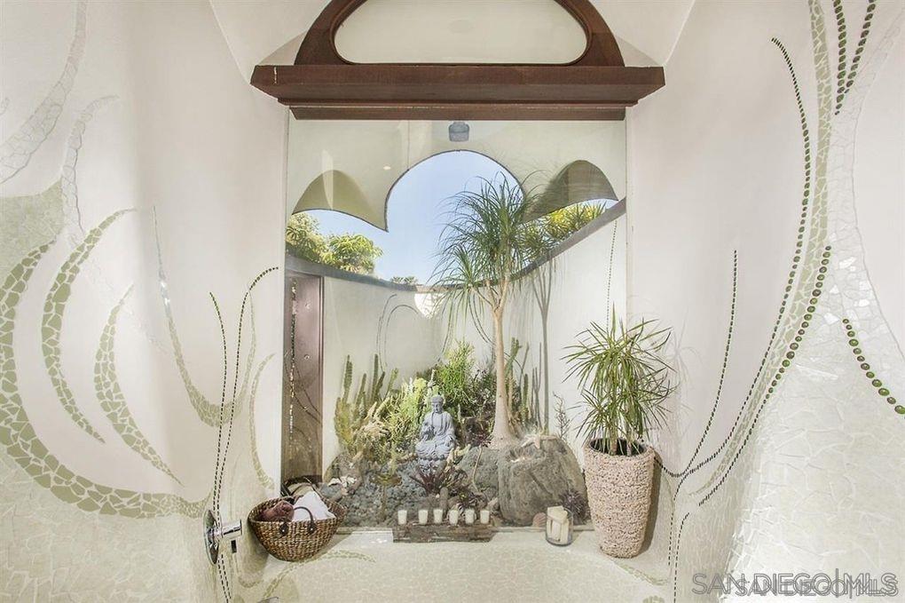 9805 Blackgold Road La Jolla, CA 92037 - Photo 21 of 32 a close view of a dining table with a potted plant
