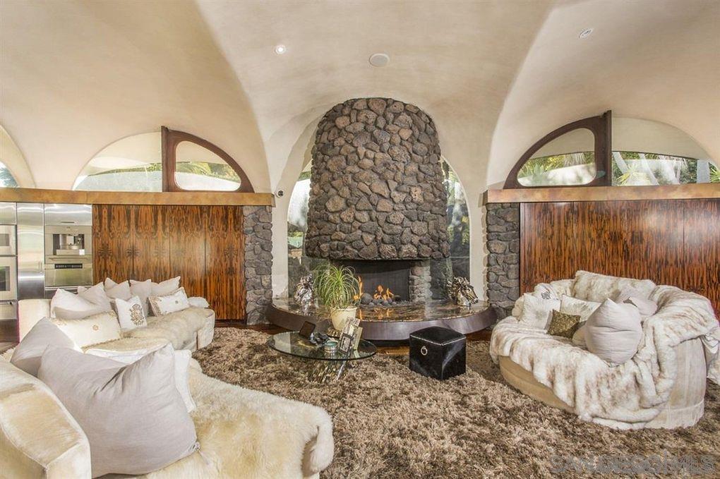 9805 Blackgold Road La Jolla, CA 92037 - Photo 22 of 32 a living room with furniture a fireplace and a large window