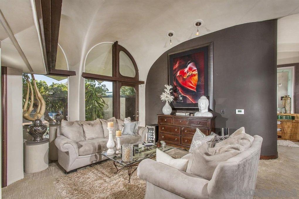 9805 Blackgold Road La Jolla, CA 92037 - Photo 25 of 32 a living room with furniture a fireplace and a floor to ceiling window