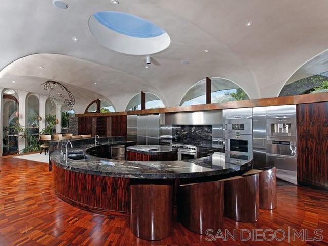 9805 Blackgold Road La Jolla, CA 92037 - Photo 8 of 32 a kitchen with stainless steel appliances granite countertop a sink a stove and a wooden floors