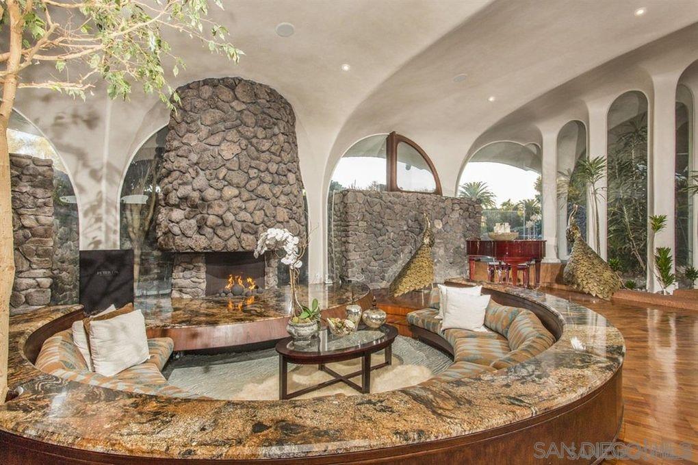 9805 Blackgold Road La Jolla, CA 92037 - Photo 10 of 32 a living room with fireplace furniture and a table