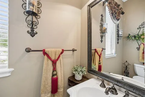 a bathroom with a sink mirror and vanity