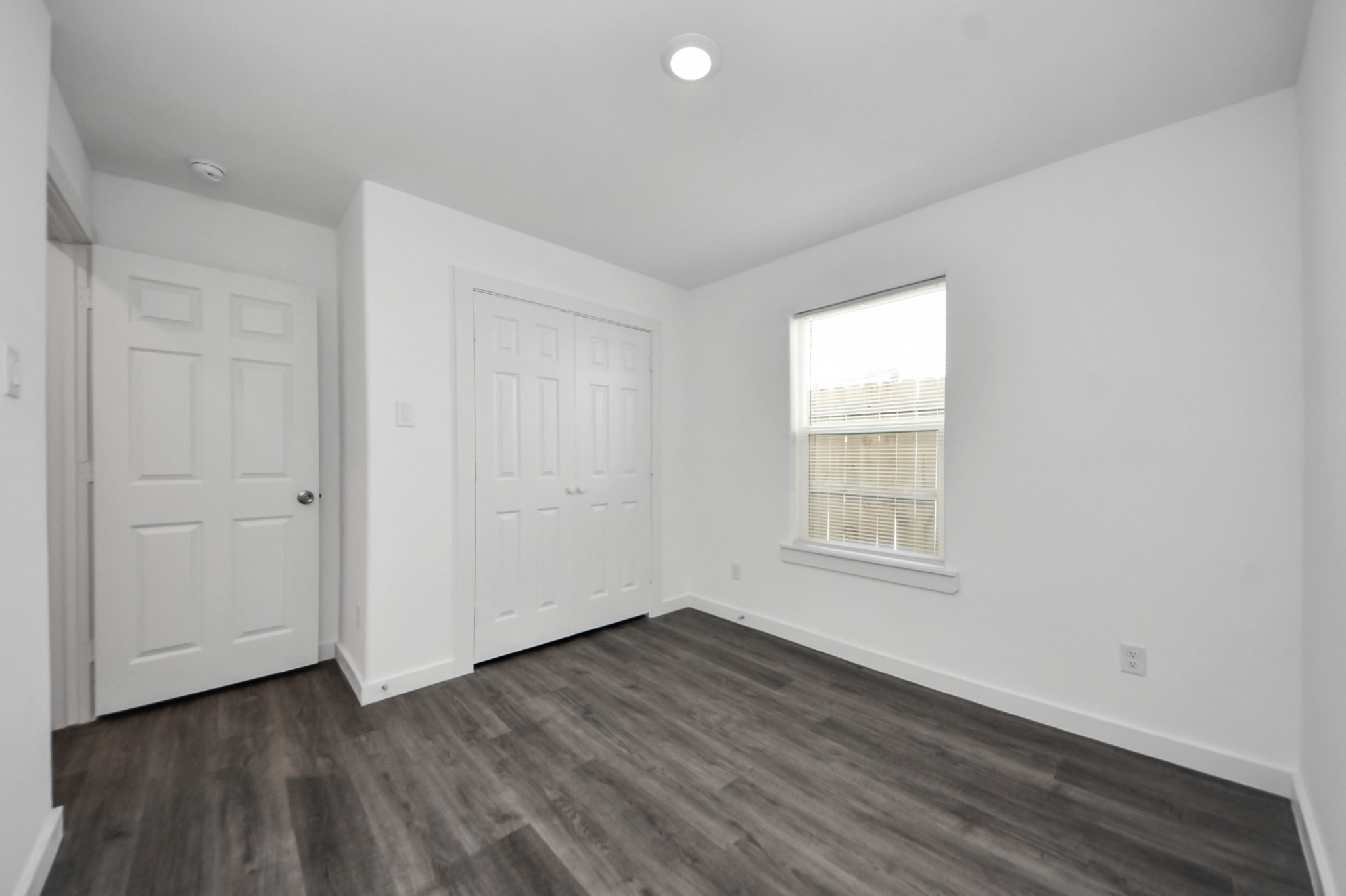 8125 Laura Koppe Road, Unit A Houston, TX 77028 - Photo 19 of 38 an empty room with wooden floor and windows