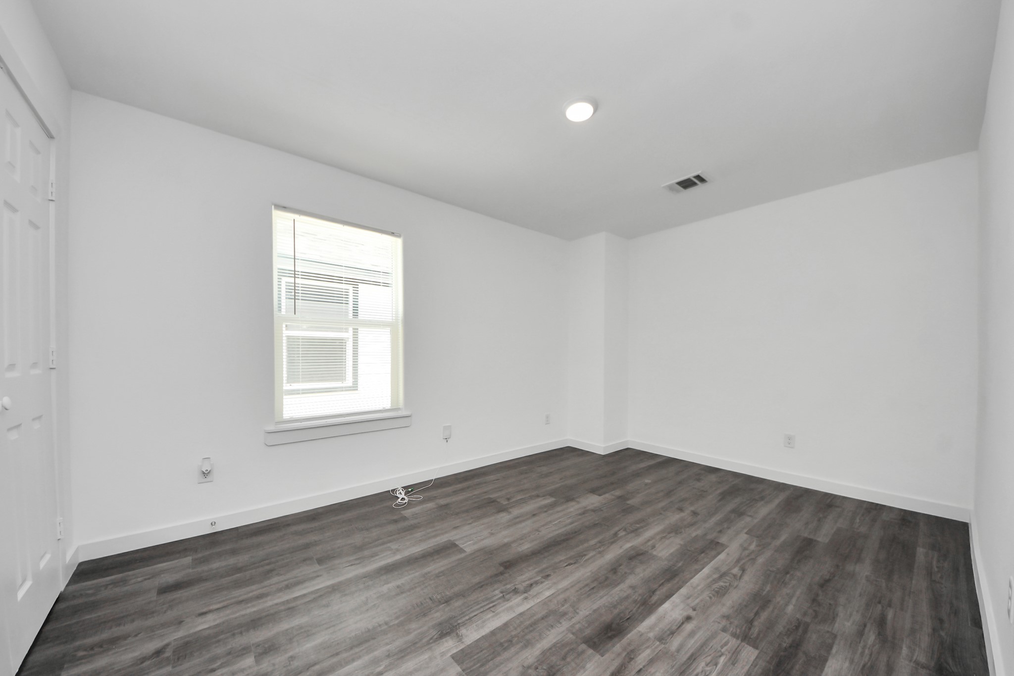 8125 Laura Koppe Road, Unit A Houston, TX 77028 - Photo 32 of 38 an empty room with wooden floor and windows