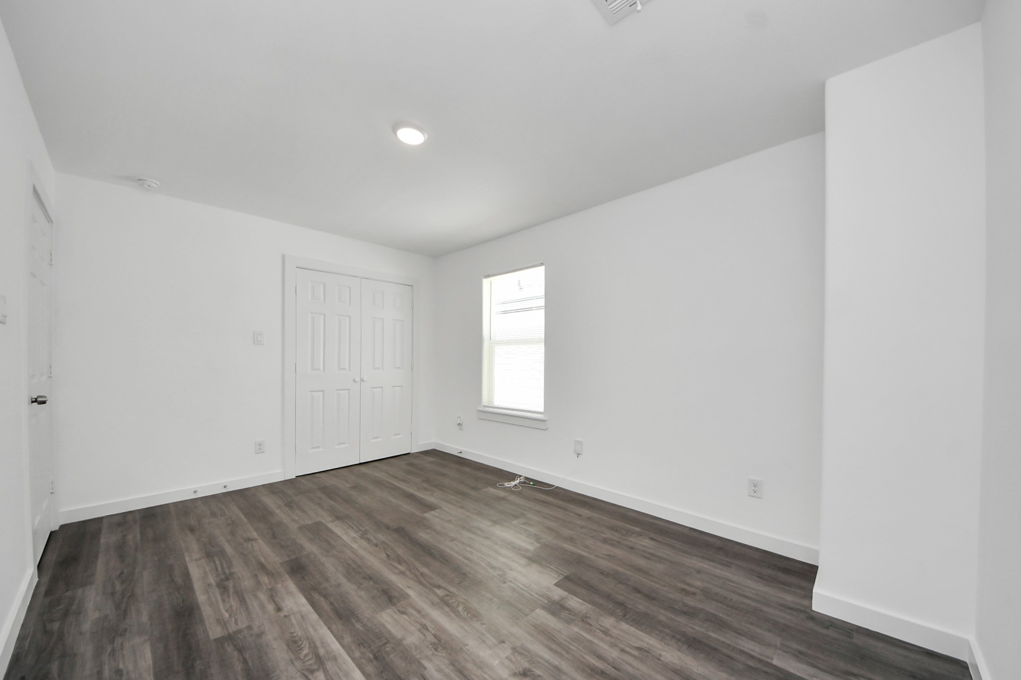 8125 Laura Koppe Road, Unit A Houston, TX 77028 - Photo 33 of 38 a view of empty room with wooden floor and fan