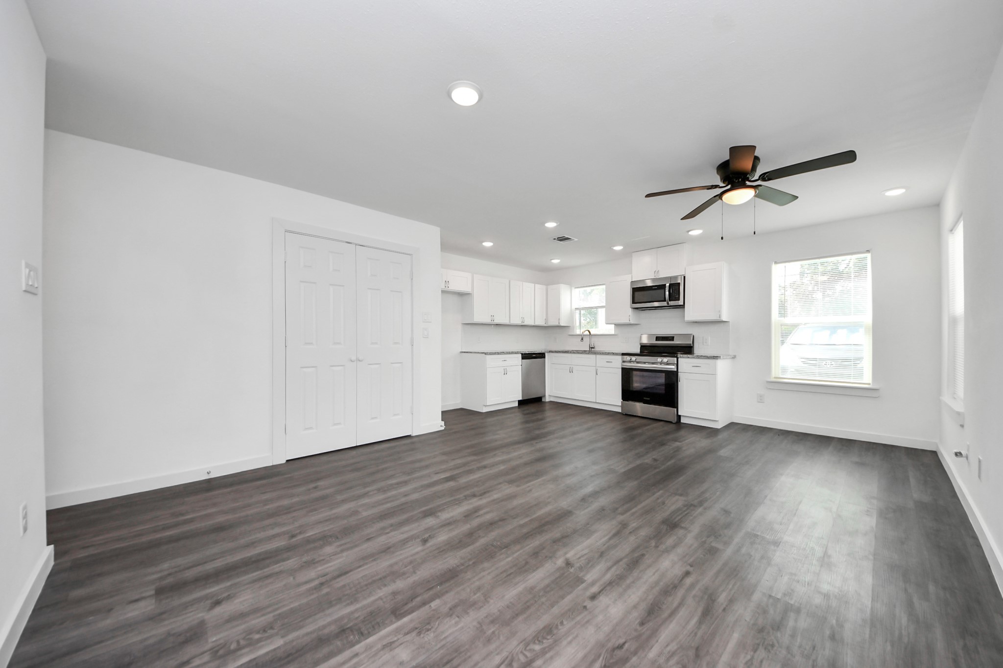 8125 Laura Koppe Road, Unit A Houston, TX 77028 - Photo 6 of 38 a view of kitchen with stove and wooden floor