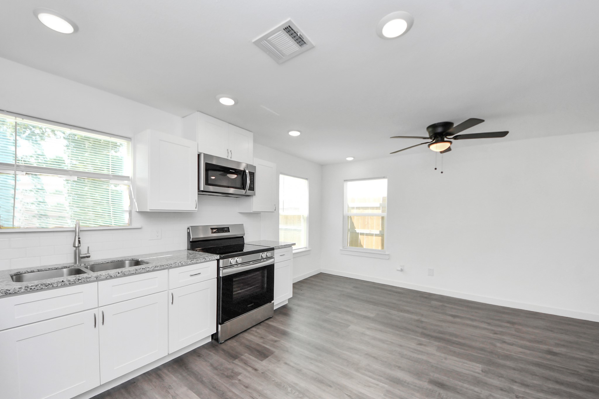 8125 Laura Koppe Road, Unit A Houston, TX 77028 - Photo 10 of 38 a kitchen with granite countertop a sink stainless steel appliances and window