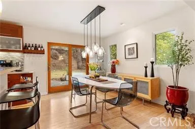 a view of a dining room with furniture and chandelier