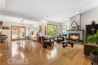 a living room with furniture large window and fireplace