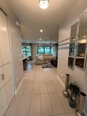 a lobby with furniture and a potted plant