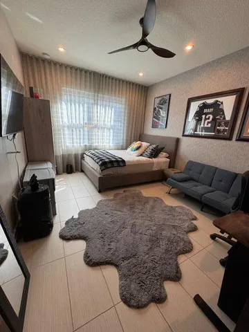 a bedroom with a bed window and couch